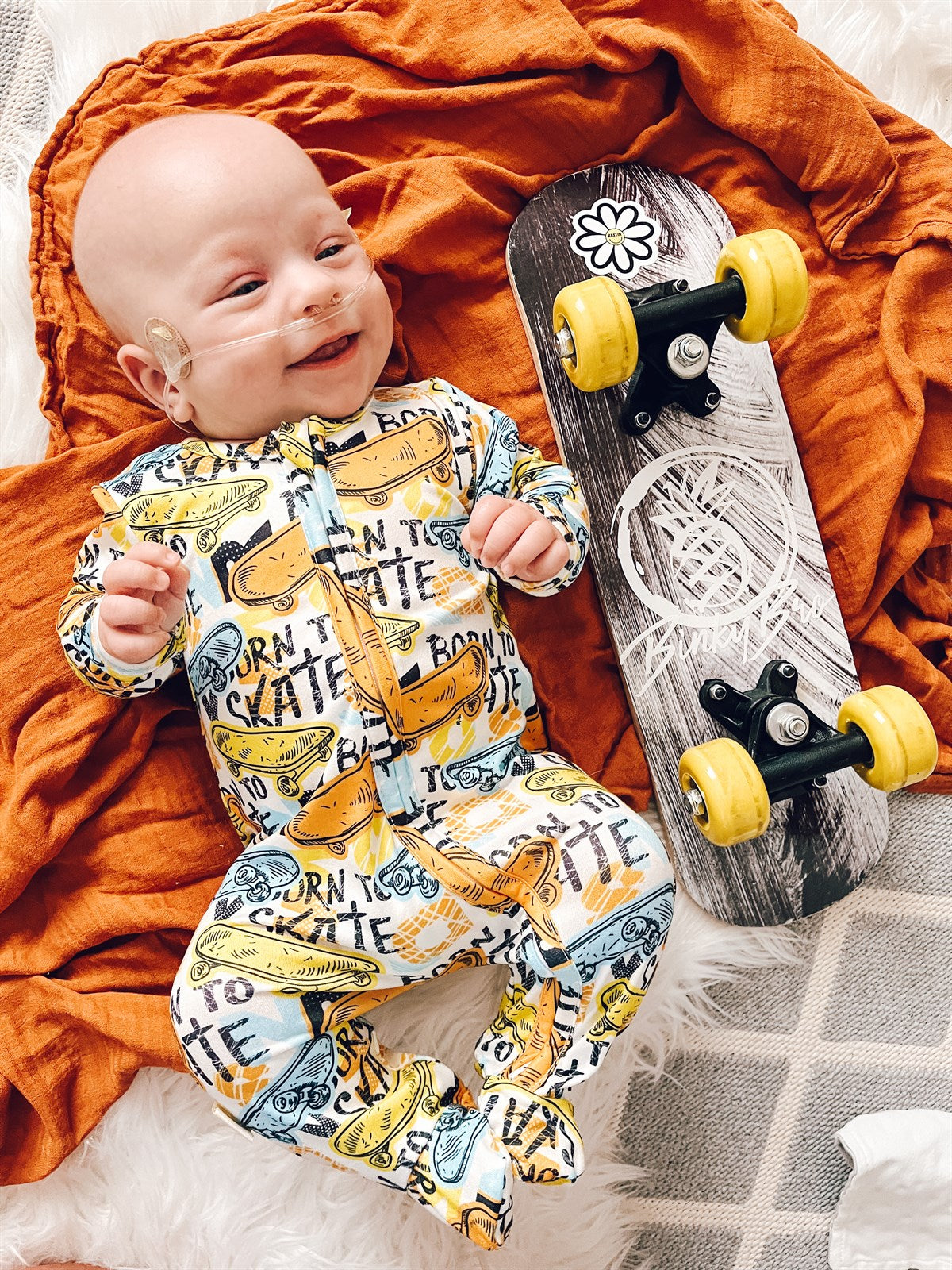 boy wearing the Boys Zippies Sleepers - Born To Skate with a skateboard next to the child