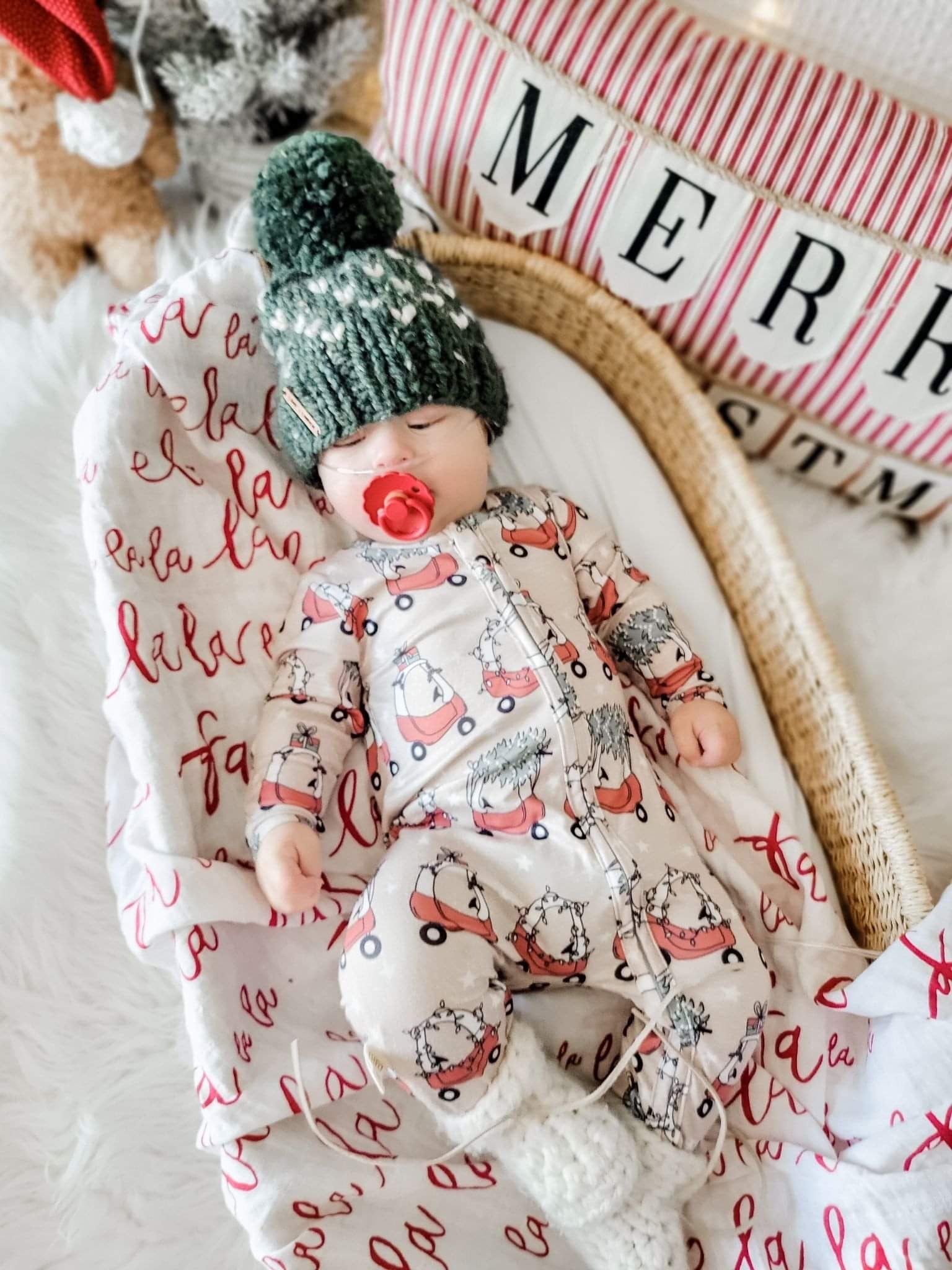 kid wearing the Holiday Baby Zippies Sleepers - Lil Tykes Car Holiday with green knit hat