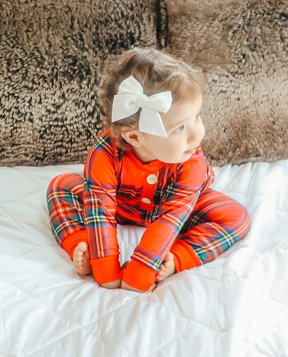baby wearing the red tartan plaid pajama's 2 piece set.