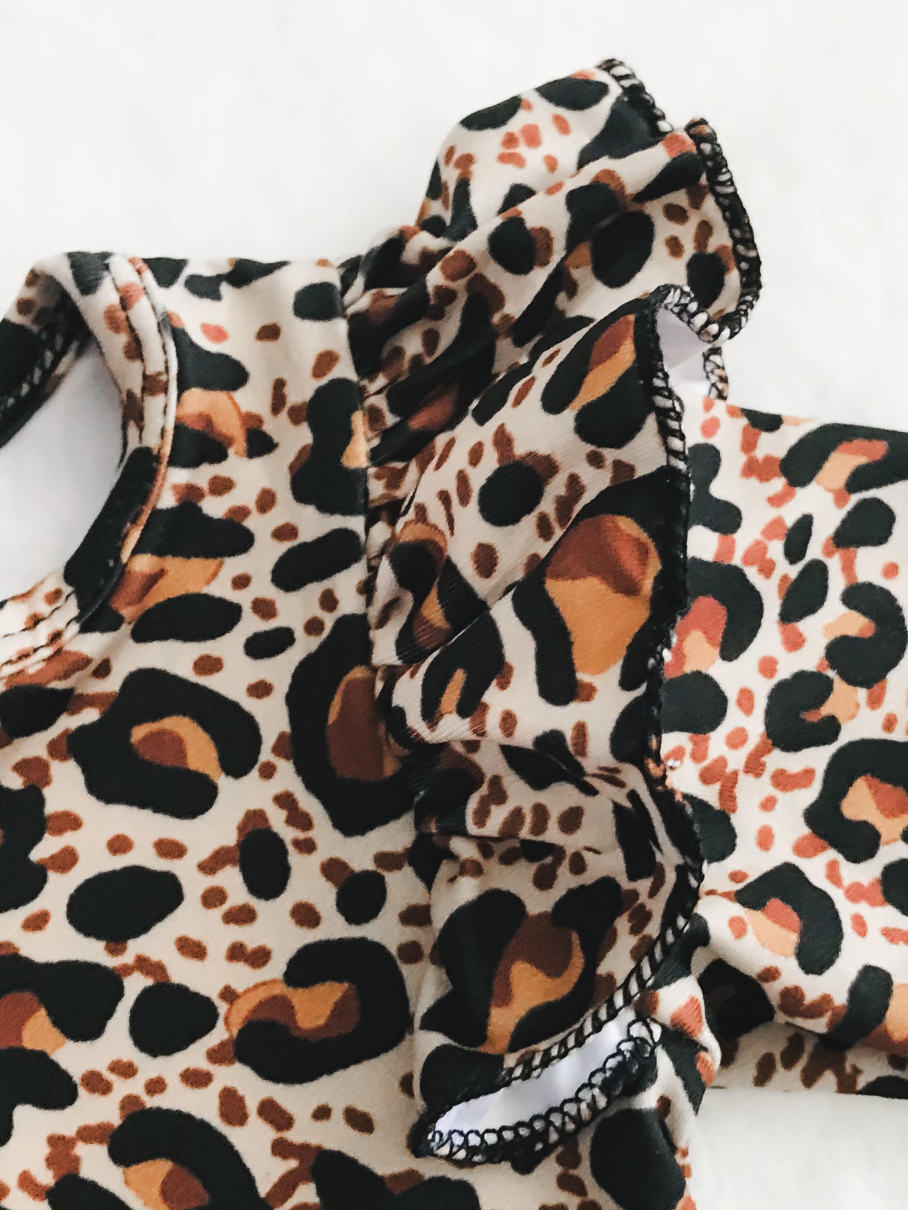 Baby Girls Leopard Deluxe Romper - close up of ruffle shoulder detail