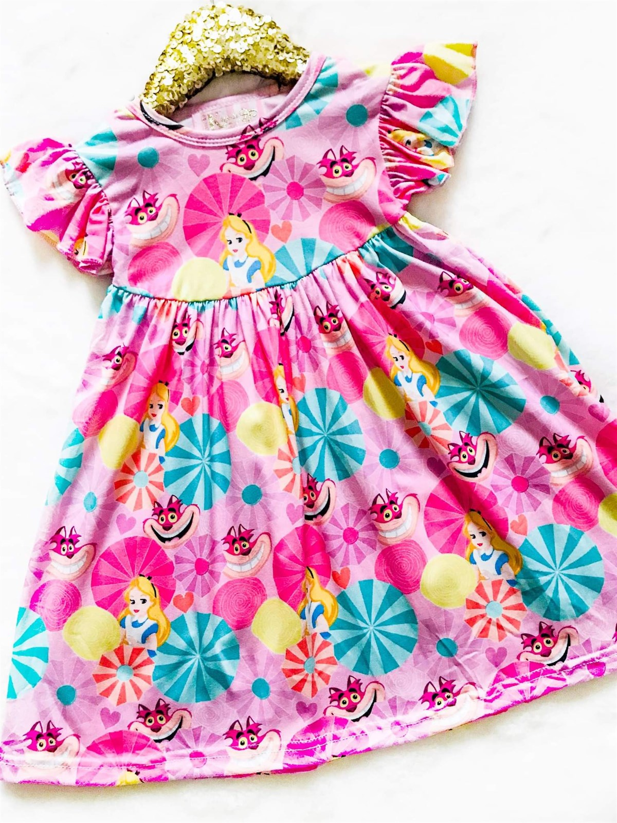 Girls Fun Character Dresses - Wonderland Smile Cat | Pink - colorful swirly circles that are pink, blue and yellow