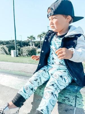 Boy wearing the Boys 2-Piece Short Sleeve Pajamas - Blue Mamas Boy Skateboards plus lightning bolts, sneakers, and theo & me hats as the pattern