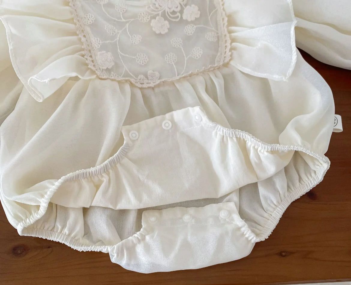 Baby Girls Romper - Ivory Ruffle with Lace Embroidered Bodice - showing snaps at bottom