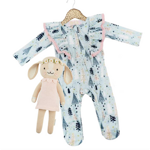 Kryssi Kouture Sienna Holiday Infant Deluxe Tutu Jumpsuit - Blue Winter Trees Pom. Has white, navy blue, and tan trees. There are pink poms on the pattern ruffles on the shoulders.