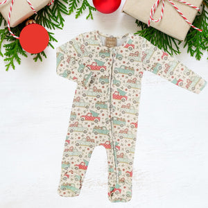 Holiday zippies sleepers with red, green, & seafoam pastel patterned vintage trucks carrying varying holiday items like trees & candy canes