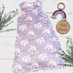 full length baby girls sleeveless sleep bag with purple peony floral print and ruffle details on the zipper area top to bottom.