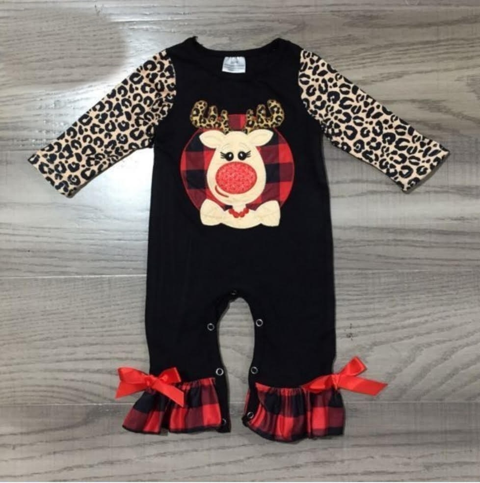 Baby & Toddler Ruffled Romper Jumpsuits - Black Rudolph. Bodice is black with a reindeer with leopard antlers on the chest. There are leopard sleeves, and the feet area has buffalo plaid ruffles with red bows.