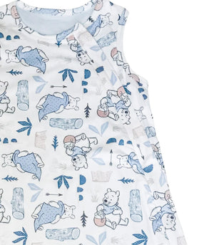 up close details on the baby sleeveless sleep bag with blue tinge pooh bear print. Shows zipper located on the right side of the photo. zipper will be on left side of baby when worn.