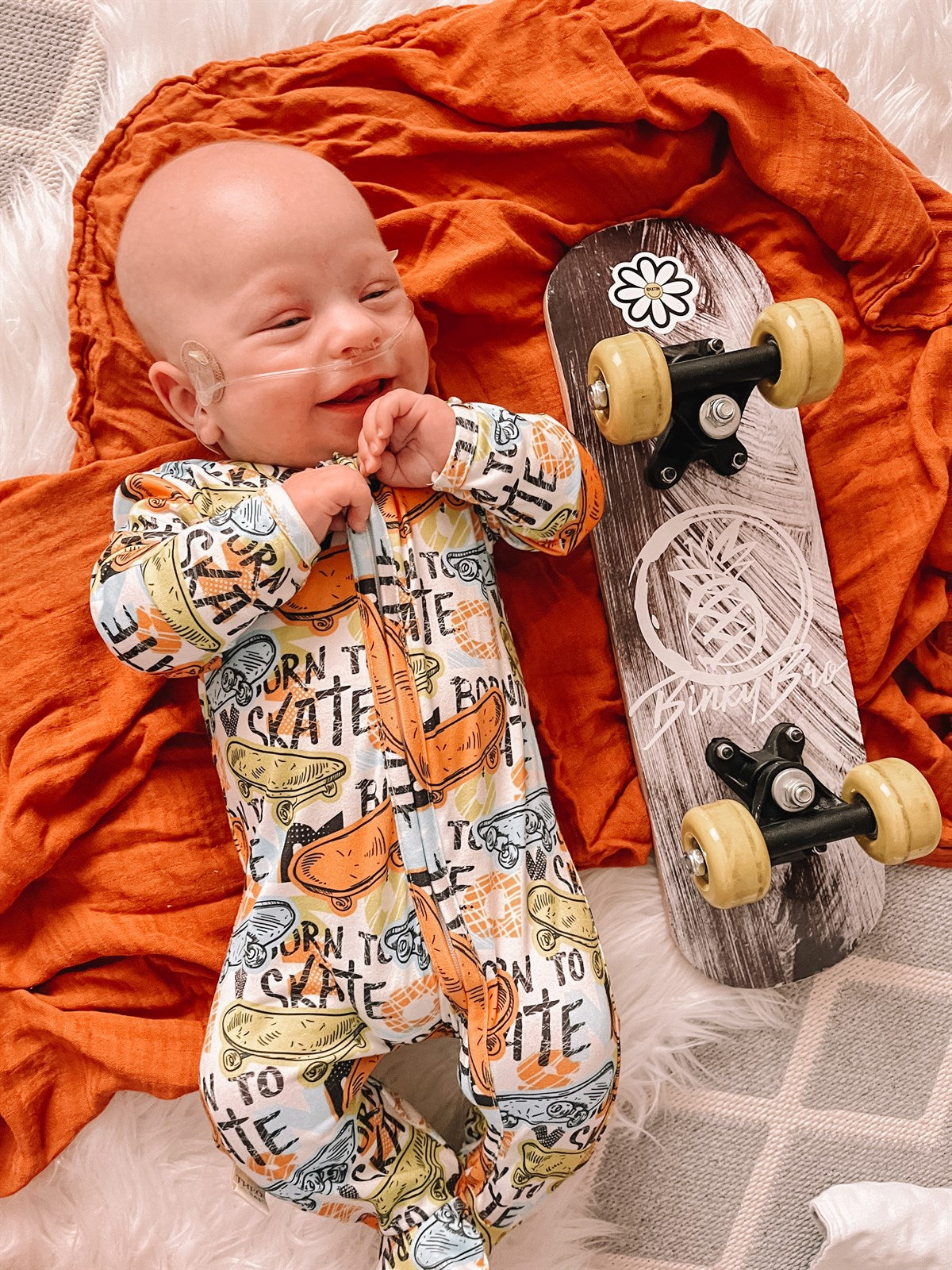 boy wearing the Boys Zippies Sleepers - Born To Skate with the skateboard next to him