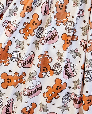 close up of the Girls Fun Vacation Character Dresses - Magic Hot Cocoa & Ginger Friends dress. Shows holly, gingerbread cookies, disco balls, & magic mugs with marshamallows