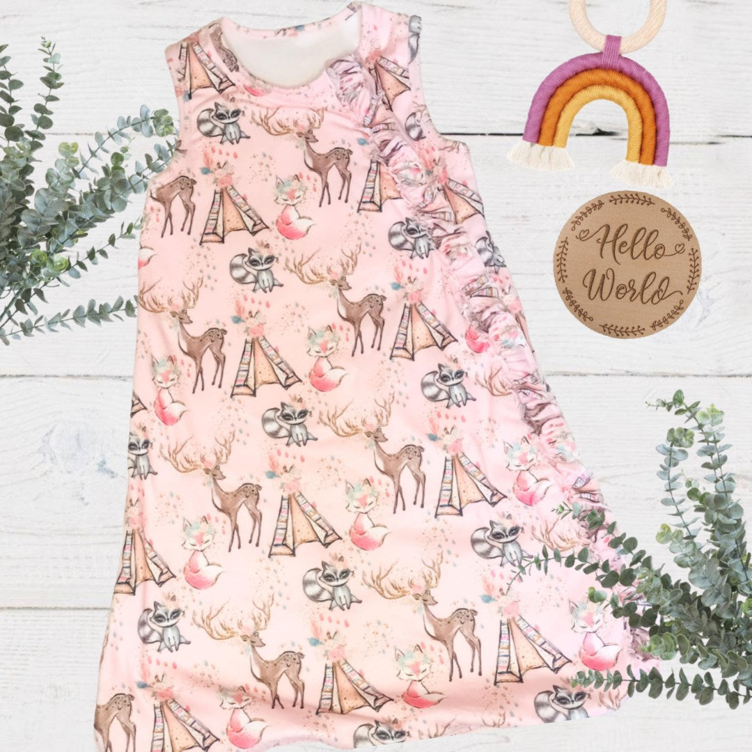 full length of the baby sleeveless sleep bag with pink forest friends print. Zipped up to the top.