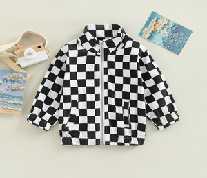 black and white jacket full zip flatlay with various items surrounding it