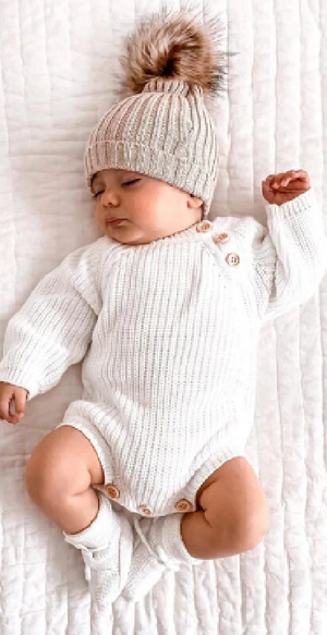 baby in white rib long sleeve button romper