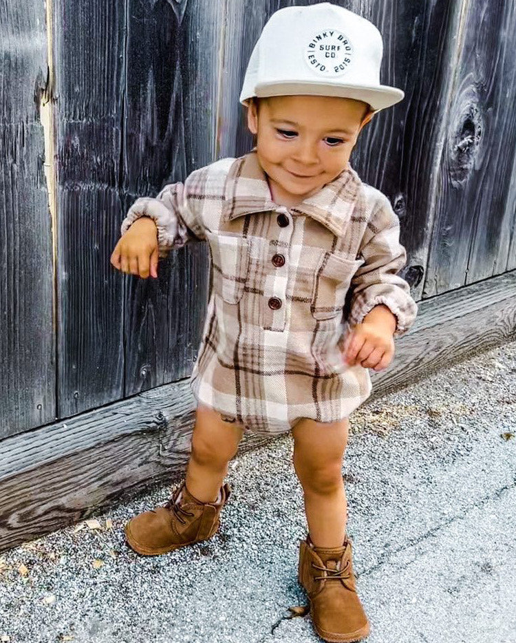 Kid wearing the Kids Dark Tan Plaid Hooded Flannel Romper with white hat & brown boots