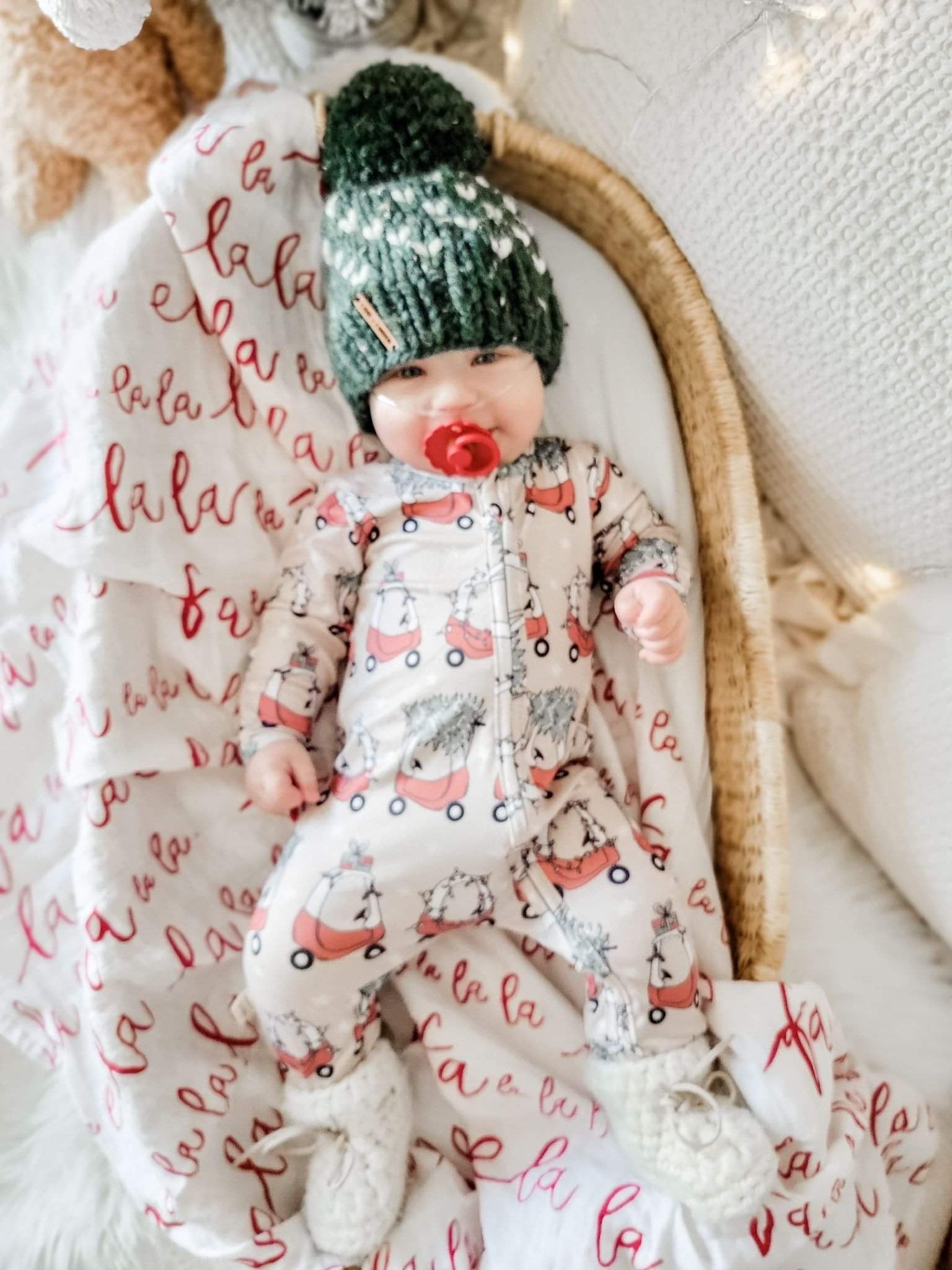 kid wearing the Holiday Baby Zippies Sleepers - Lil Tykes Car Holiday with green knit hat & white knit socks