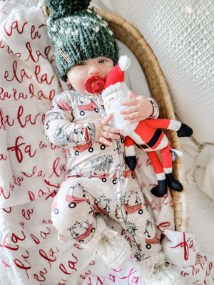 kid wearing the Holiday Baby Zippies Sleepers - Lil Tykes Car Holiday with green knit hat & toy santa