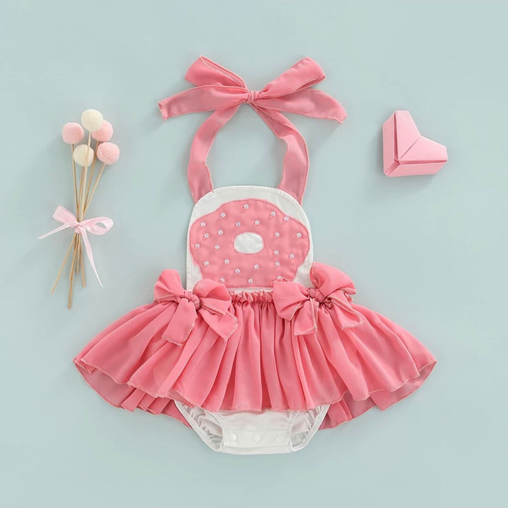 Baby Girls Pink Doughnut Peek-a-Boo Birthday Romper Front. Includes pink tulle skirt with 2 bows, pearls on the doughnut bodice, and soft pink halter tie.