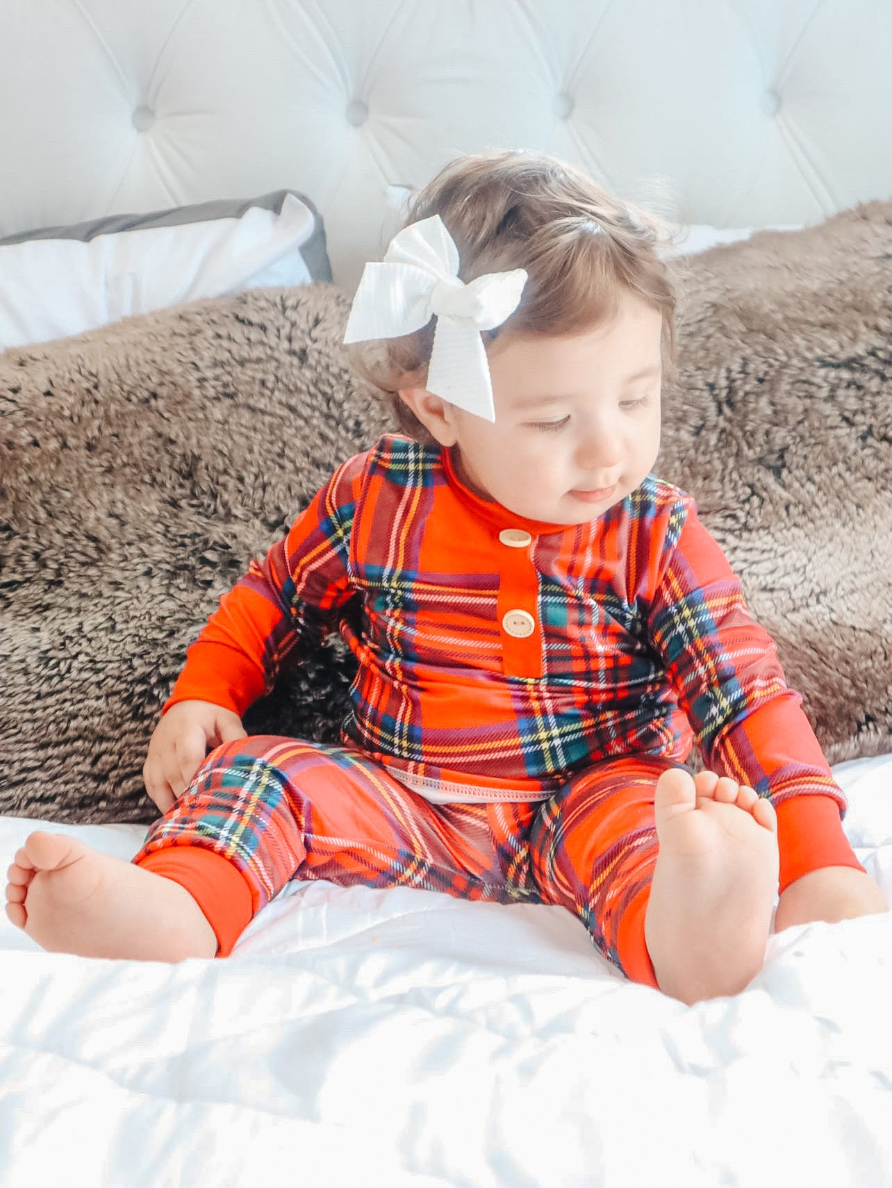 baby wearing the red tartan plaid pajama's 2 piece set.